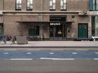 bicycle parked next to a building on a city street with a sign that says brunno