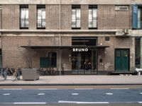 bicycle parked next to a building on a city street with a sign that says brunno