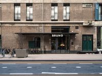 bicycle parked next to a building on a city street with a sign that says brunno