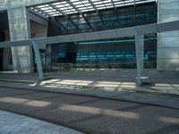 a building that has a blue sky overhead and lots of glass around it in the background