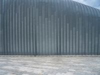 grey metal wall with many tiles near by and on top of it's brick surface