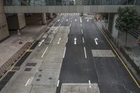 an aerial view of a roadway that has arrows on both sides and yellow lines down the middle