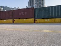 a parking lot has a bunch of containers on it's sides, and the end of a car