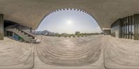 this is a 360 - lens image of a building with stairs and a bench outside