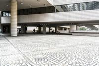 a large white building with windows and a tiled courtyard outside it is covered in many different designs