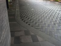 sidewalk with two empty umbrellas on it in a city street, during the evening