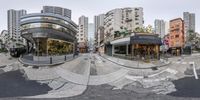 the 360 - lens view shows people outside a city buildings building, and a circular storefront