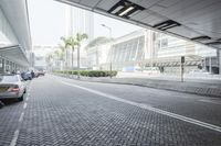 a person riding a red motorcycle on a brick road next to buildings and palm trees