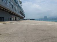 a airplane is parked at the airport on a cloudy day in hong kong, kong kong