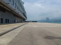 a airplane is parked at the airport on a cloudy day in hong kong, kong kong