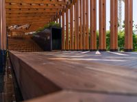 an empty patio with a wooden structure and many lights above it, the building is empty