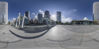 a view of a large city from below a circular mirror showing the street view of the city