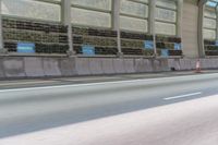 a car driving down a highway with produce lined on it's side and a person riding a motorcycle behind