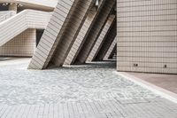 several steps up to a brick building that is lined with stone tiles in front of it