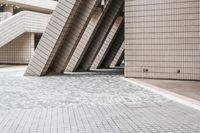 several steps up to a brick building that is lined with stone tiles in front of it