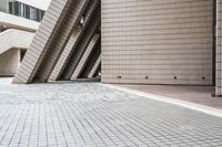 several steps up to a brick building that is lined with stone tiles in front of it