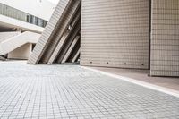 several steps up to a brick building that is lined with stone tiles in front of it