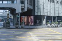 yellow lines painted on the street of a city street with people walking around and parked motorcycles next to them