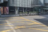 yellow lines painted on the street of a city street with people walking around and parked motorcycles next to them