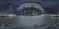 a big circular object in a very pretty place outside the city building at night,