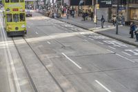 two trains running along the train tracks near a building and street with a bicycle in the distance