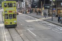 two trains running along the train tracks near a building and street with a bicycle in the distance