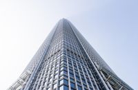 this high rise building is made from glass and steel elements, looking up at the top