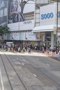 two trains running along the train tracks near a building and street with a bicycle in the distance