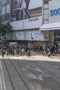two trains running along the train tracks near a building and street with a bicycle in the distance
