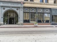 the entrance to the hotel bartty, where patrons are walking on the street in front of it