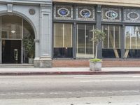 the entrance to the hotel bartty, where patrons are walking on the street in front of it