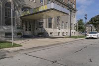this building has a sign that reads the hotel on it's corner of the street
