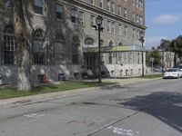 this building has a sign that reads the hotel on it's corner of the street