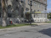 this building has a sign that reads the hotel on it's corner of the street