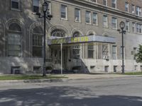 this building has a sign that reads the hotel on it's corner of the street