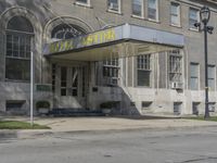 this building has a sign that reads the hotel on it's corner of the street