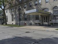 this building has a sign that reads the hotel on it's corner of the street