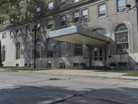 this building has a sign that reads the hotel on it's corner of the street