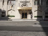 the entrance to the hotel has many large flags flying from it's front door