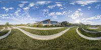 the 360 - view of a house is looking up at the sky while the hill goes down to the grass