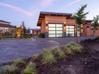 a large garage is shown outside in this picture to the side of the house with driveway leading up to it