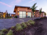 a large garage is shown outside in this picture to the side of the house with driveway leading up to it