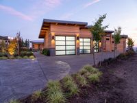 a large garage is shown outside in this picture to the side of the house with driveway leading up to it