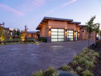 a large garage is shown outside in this picture to the side of the house with driveway leading up to it