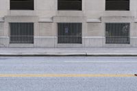 a lone skateboarder stands on the sidewalk at an intersection with a fire hydrant