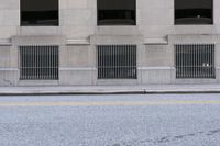 a lone skateboarder stands on the sidewalk at an intersection with a fire hydrant