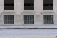 a lone skateboarder stands on the sidewalk at an intersection with a fire hydrant