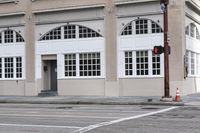 an image of a corner with traffic lights and a crosswalk in front of the building