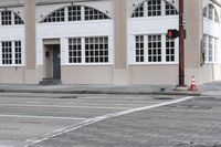 an image of a corner with traffic lights and a crosswalk in front of the building