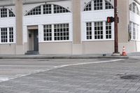 an image of a corner with traffic lights and a crosswalk in front of the building